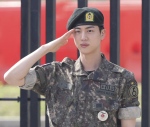 K-pop band BTS's member Jin salutes after being discharged from a mandatory military service outside of an army base in Yeoncheon, South Korea, Wednesday, June 12, 2024. (Im Byung-shik/Yonhap via AP)